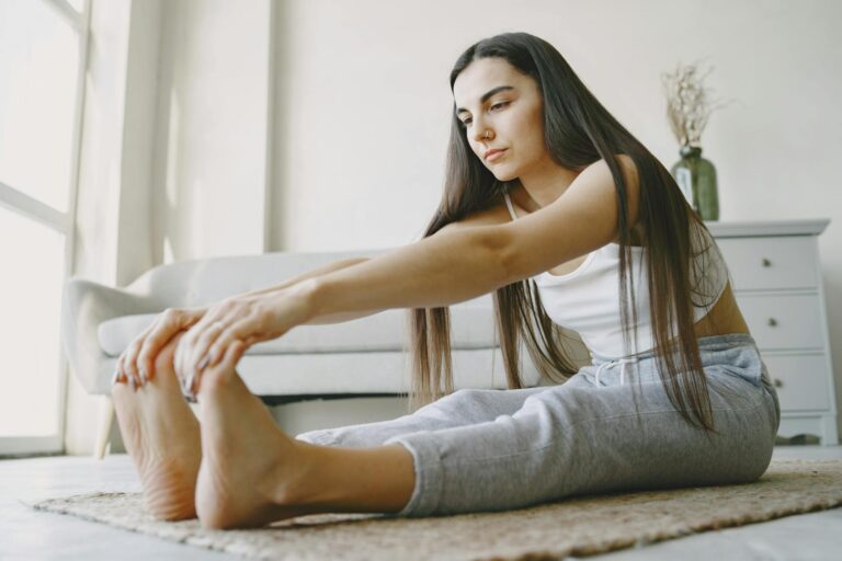 Young woman stretches on a rug in a light-filled room, embracing home fitness.