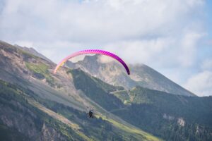 Experience thrilling paragliding over stunning mountain landscapes, perfect for adventure seekers.