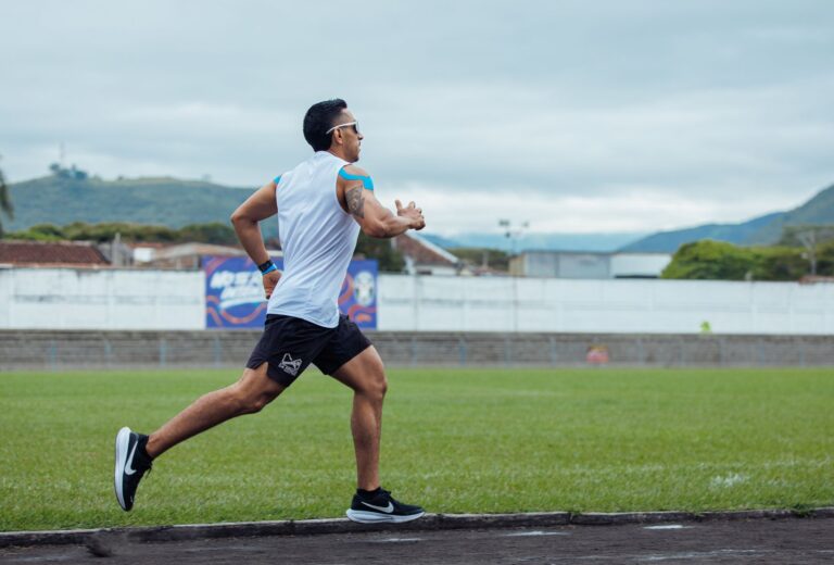 Man sprinting on outdoor track in Guadalajara de Buga, Colombia, showcasing intense athletic performance.