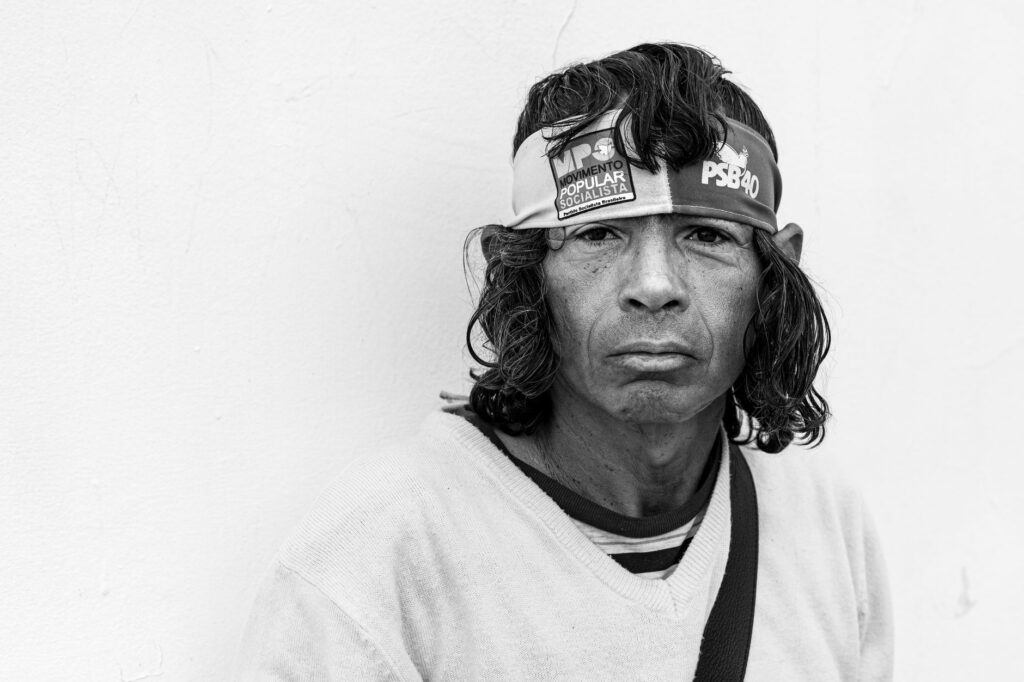 Emotive black and white portrait of a man wearing a headband, showcasing a serious expression.